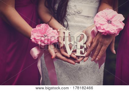 Bride with his girlfriends holding the inscription love