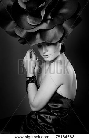 black and white portrait of a girl in a dark roses suit