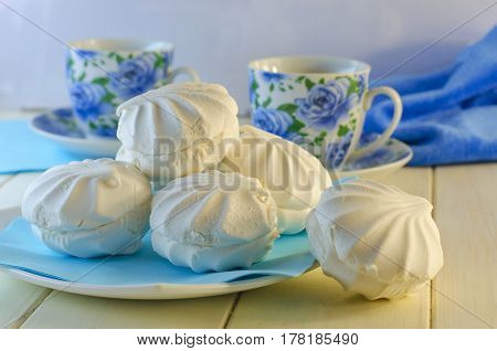 White vanilla marshmallows in a plate on a white background