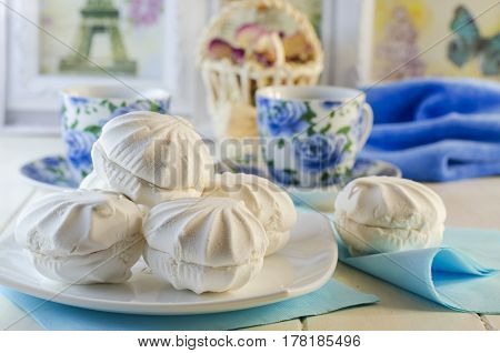 White vanilla marshmallows in a plate on a white background