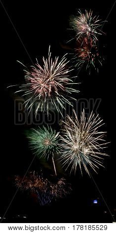 long exposure of multiple fireworks against a black sky