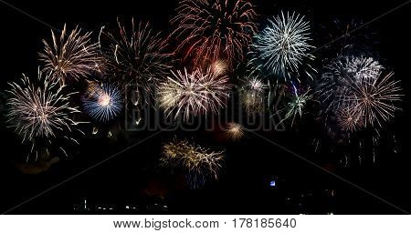 long exposure of multiple fireworks against a black sky