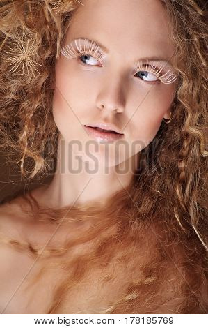 portrait of beautiful curly girl on a beige background