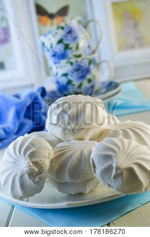 White vanilla marshmallows in a plate on a white background