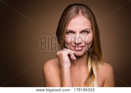 Portrait of beautiful woman on beige background