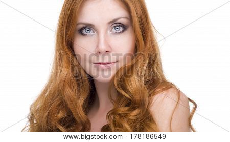 studio portrait of pretty redhead girl on a light background.