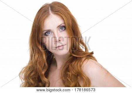 studio portrait of pretty redhead girl on a light background.