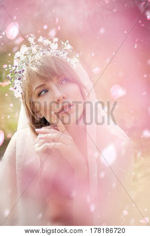 portrait of a beautiful blonde girl in a flowering garden
