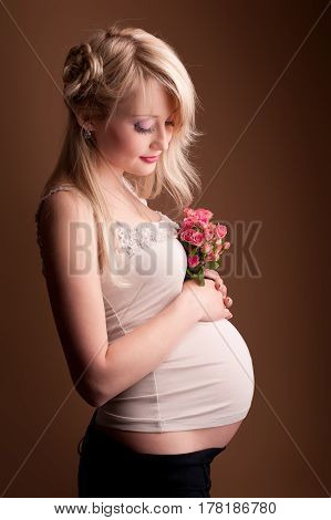 Photo portrait of a lovely young pregnant woman in a photo studio.