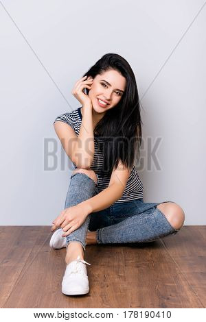 Photo Of Cute Attractive Young Smiling Woman With Long Hair And Striped Shirt Sittind On The Floor