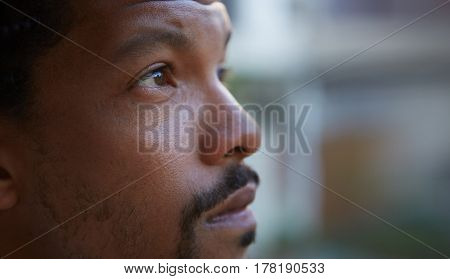 Close up portrait of a serius young bearded black guy.
