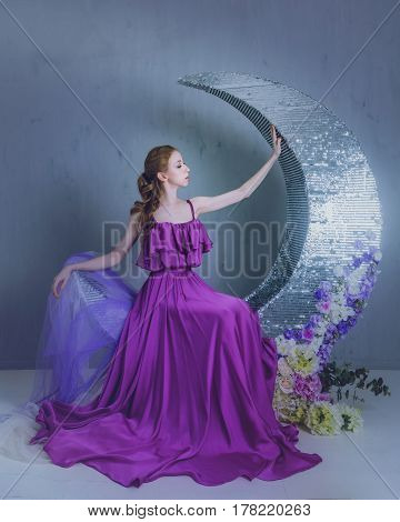 Cute girl dancer in a beautiful dress posing in the studio. Tinted photos.
