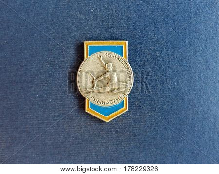 USSR - CIRCA 1979: Badge with a picture of a gymnast and the inscription 