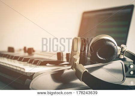 Golden Music Studio headphone lying on working desktop in vitnage tone