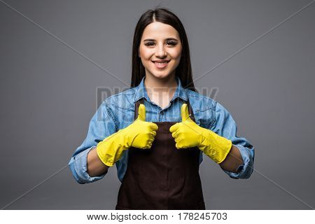 Cleaner Woman Thumbs Up With Yellow Gloves On The Grey Background