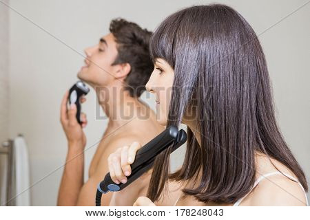 Couple shaving brushing hair and getting ready in the morning