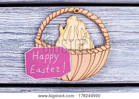 Plywood bunnies and basket. Easter congratulatory card. Wishes for Easter holiday.