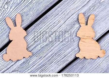 Plywood Easter rabbits. Cutout figurines of bunnies. Animalistic decorative items.