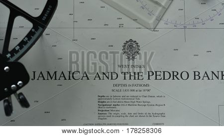 Navigation tools (pen, sextant, divider, parallel rule) on chart
