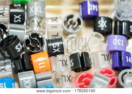 Plastic Labels Indicating The Size Of Clothes For Hangers In A Box