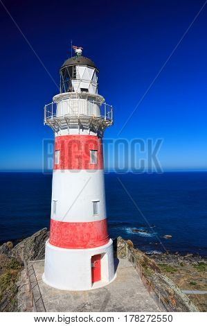White and red striped lighthouse, location - Cape Palliser bay lighthouse, Wairarapa, North Island, New Zealand