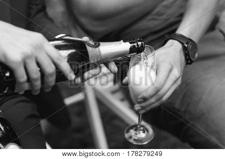 Pictures of man pours champagne in the glass