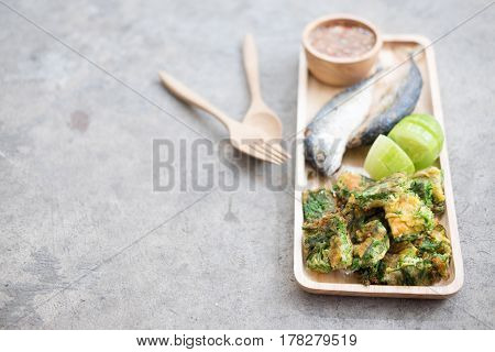 Thai local popular food as spicy shrimp paste dip (Nam Prik Kapi in Thai) served with fried mackerels sliced cucumber and fried acacia pennata omelet