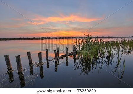 Sunset Over Lake With Bank Protection Barrier