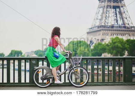 Woman Riding A Bicycle On A Street Of Paris