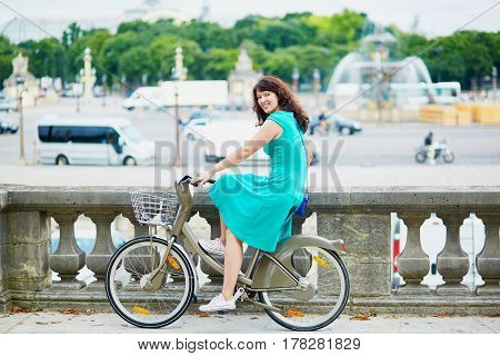 Woman Riding A Bicycle On A Street Of Paris
