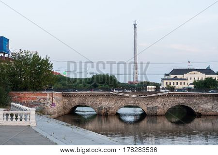 Yekaterinburg Russia - August012016: View to stone bridge over the Iset river and the TV tower from the Historic Square in summer evening.