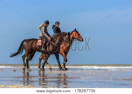 Kijkduin the Netherlands - March 24 2017: horseback riders enjoying the spring weather on the beach
