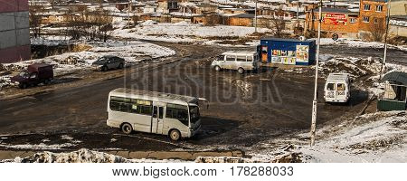 Kazakhstan, Ust-Kamenogorsk, march 12, 2017: Top view of the final bus stop, minibuses, urban outskirts