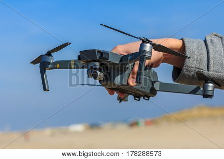 Kijkduin the Netherlands - March 24 2017: man holding quadcopter drone
