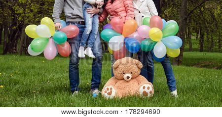 Legs in family gym shoes close-up with balloons on holiday