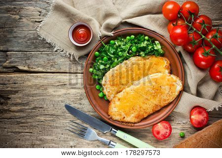 German-style chicken schnitzel with fresh vegetable top view