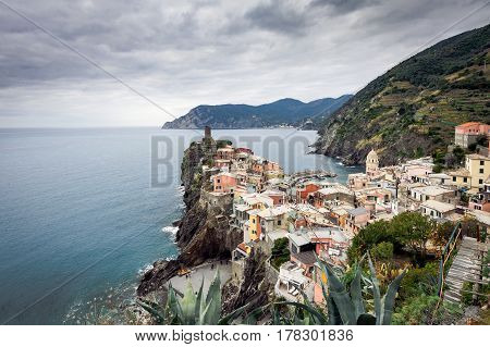 Old medieval watchtower and old houses on cliffs of  Vernazza town at Cinque Terre national park, Italy