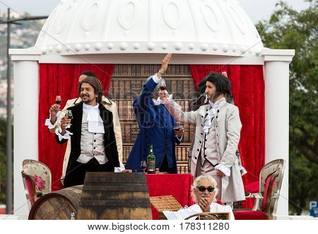 FUNCHAL MADEIRA PORTUGAL - SEPTEMBER 4 2016: Men in historical fashion dress raise toasts durnig historical and ethnographic parade of Madeira Wine Festival in Funchal. Madeira Portugal