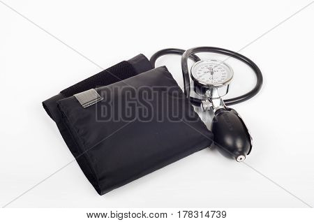 Health care concept - blood preasure cuff monitor and stethoscope on white backgroun