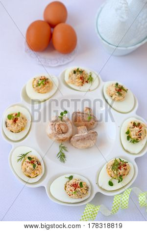 Hard-boiled eggs cut in half and filled with  champignons.