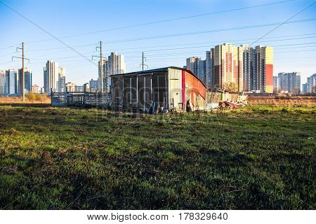 The old shed near new high-rise buildings of the city. Kyiv Ukraine.