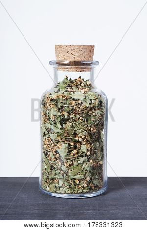 Dried hawthorn herb inside a glass jar. Herbs and plants for tea.