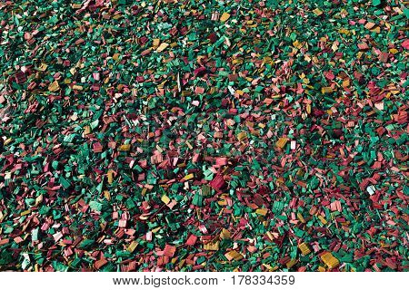 Colored wooden sawdust pieces texture close-up background