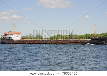 Old bulk carrier on river. Logistic concept
