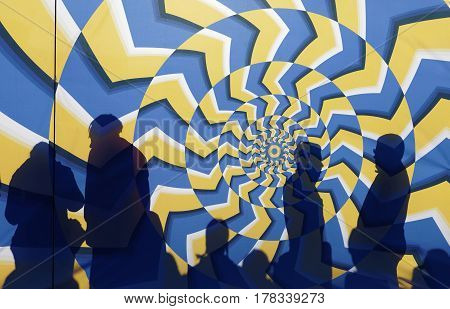 STOCKHOLM SWEDEN - MAR 25 2017: Silhouette of people behind a colorful psychedelic abstract startgate waiting for the start in the Stockholm Tunnel Run Citybanan 2017. March 25 2017 in Stockholm Sweden
