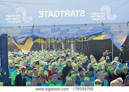 STOCKHOLM SWEDEN - MAR 25 2017: Crowd of runners men and woman in blue vests and yellow bandeau waiting for the start in the Stockholm Tunnel Run Citybanan 2017. March 25 2017 in Stockholm Sweden
