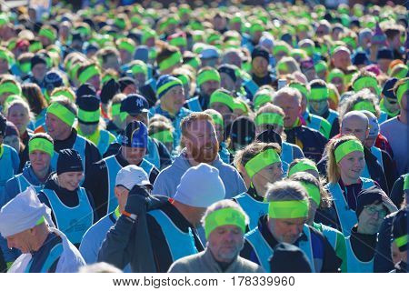 STOCKHOLM SWEDEN - MAR 25 2017: Crowd of runners men and woman in blue vests and yellow bandeau waiting for the start in the Stockholm Tunnel Run Citybanan 2017. March 25 2017 in Stockholm Sweden