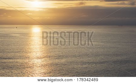 Clouds sky and sunlight sunset on horizon ocean. Silhouette person on background seascape dramatic atmosphere rays sunrise. Relax view waves water sea mockup nature evening concept perspective sunrise