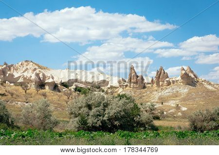 Rock formations landscape photography of Cappadocia in Central Anatolia. The great tourist attraction - mountains in Goreme National Park outdoor Turkey at sunny summer day