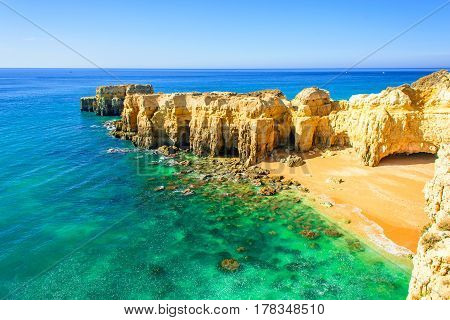 beautiful sea view with secret sandy beach among rocks and cliffs near Albufeira in Algarve Portugal